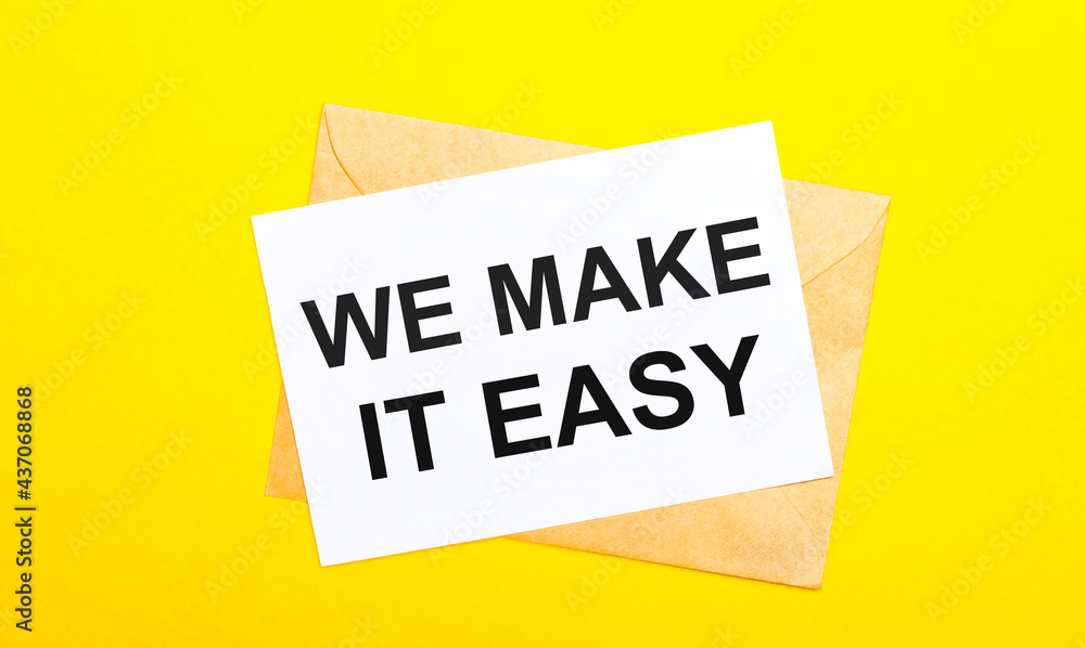 Poster on a yellow background, an envelope and a card with the text we make it easy. view from above