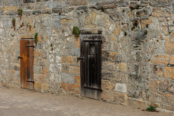 Old wooden doors in the stone wall