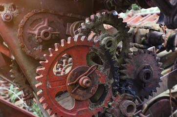 Rusty old metal gears in a broken combine unit. Remains of the old mechanism