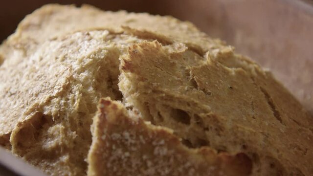 BAKING - Sourdough bread fresh from the oven, slow motion close up pan left