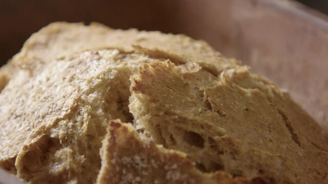 BAKING - Sourdough bread fresh from the oven, slow motion close up