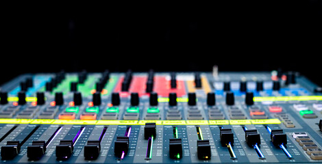 Sliders and buttons on Audio Mixing Desk at live event.