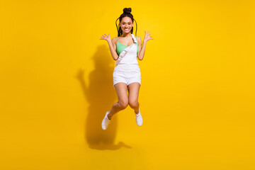 Fototapeta na wymiar Full body photo of afro american young charming lady jump up funky mood isolated on yellow color background