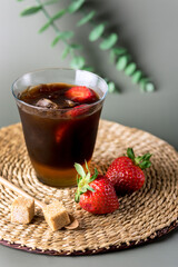 Glass of Homemade Cold Brew Coffee to Drink for Breakfast Summer Beverage with Ice Cubes Green Background Vertical