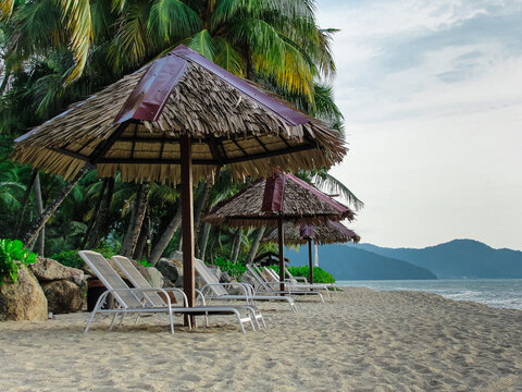 Batu Ferringhi beach, Penang, Malaysia, Sunbeds, palms, sea, ocean, mountains, sand