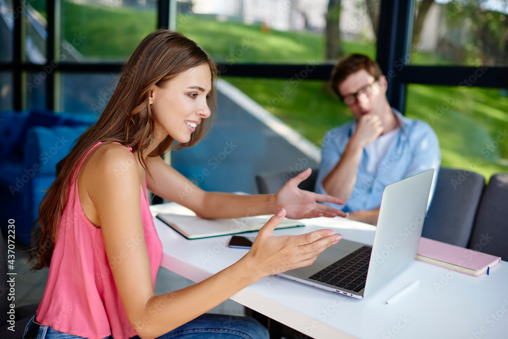 Poster skilled male and female bloggers discussing content plan during together networking on modern laptop