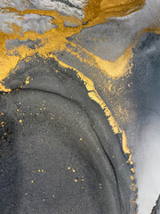 Abstract grey art with gold — black and white background with beautiful smudges, stains and splashes made with alcohol ink. Fluid art texture resembles smoke, stone, marble, watercolor or aquarelle.