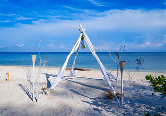 Romantic wedding ceremony by the beach in the background of the sea and blue sky. Beach weddings are full of Inspiration and the perfect venue. Gili Island, Lombok, Indonesia.