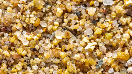 Small grains of sand on a beach, colorful background
