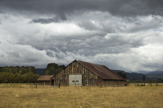 An Old Barn Under A Cloudy Sky