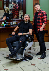 Fototapeta na wymiar hair cut and beard care for caucasian guy in barbershop, stylist