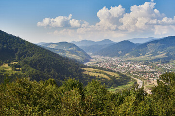 Fototapeta na wymiar Mountain landscape with river and village views. Carpathians