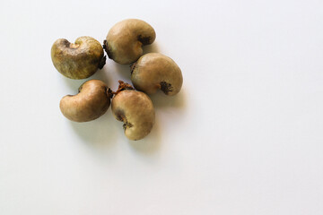 Cashew nut (Anacardium occidentale) pile, old fruits isolated on white background closeup.