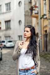 Young cute female using smartphone on the street.