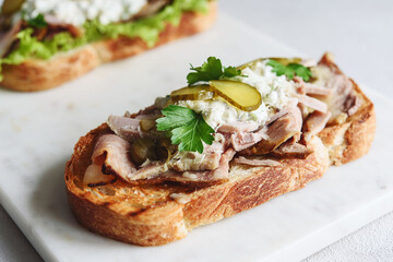Roast beef, pickle and cheese with remoulade (danish tartar sauce) Smorrebrod. Danish open faced sandwich. Selective focus