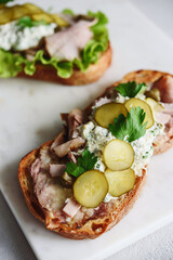 Roast beef, pickle and cheese with remoulade (danish tartar sauce) Smorrebrod. Danish open faced sandwich. Selective focus
