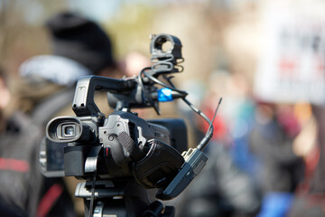 News broadcasting and recording protest on the streets.