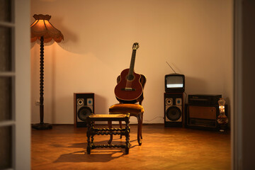 Acoustic guitar in a retro vintage room.