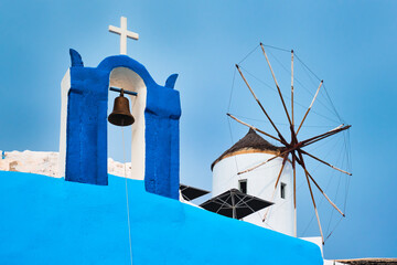 Old greek windmill on Santorini island in Oia town with stairs in street. Santorini, Greece