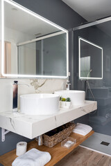 Interior of light modern bathroom with a mirror with light