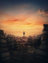 Surrealistic scene with a tiny man climbing on the top of a huge books landfill. Different thrown...
