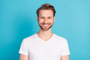 Portrait of satisfied young man toothy smile look camera wear basic outfit isolated on blue color background