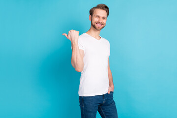Fototapeta na wymiar Photo of cheerful person put hand in pocket direct thumb empty space proposition isolated on blue color background