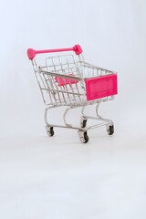 Mini shopping cart or trolley isolated on white background with copy space.