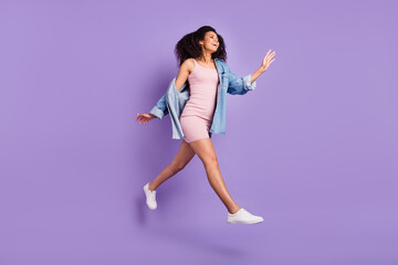 Full length body size photo woman jumping running in short dress isolated pastel violet color background