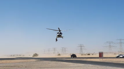 Foto op Plexiglas Police helicopter in the desert. Police training and rescue operation concept. © skymediapro