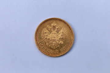 Golden coin of Russian Empire on grey background
