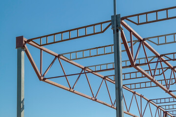 Metal beams at top of structure of building under construction. steel roof frame workshop