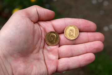 Two vintage Russian golden coins in hand