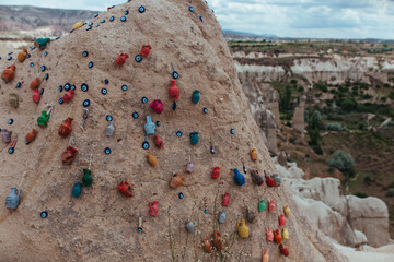 mountain in cappadocia hung with medallions from the evil eye and ceramic dishes