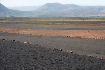 Fototapeta na wymiar Beautiful landscape at Lanzarote, Canary Islands, Spain. Volcanic land with diferent colors.