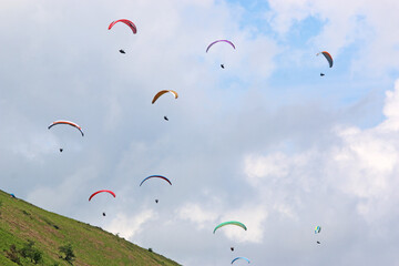 Paragliders in a blue sky	