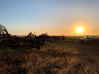 Fototapeta premium farm equipment sunrise