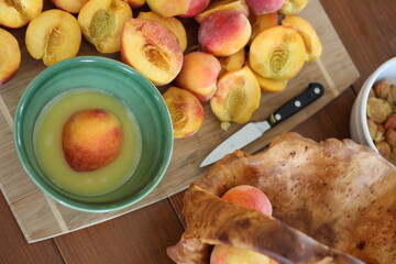 Peaches and peach in bowl in lemon juice
