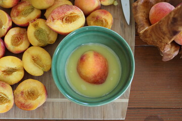 Peach in bowl with lemon juice on table