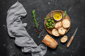 Fresh ciabatta bread on a black stone background. Italian food. Top view, flat lay.