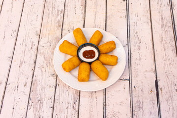 top view of chicken croquettes with sauce to dip in the center