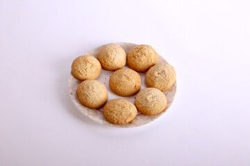 Amaretti cookies with almond on white dish.