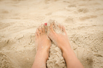 Legs on the sand. Copy space. Close up. Summer time.