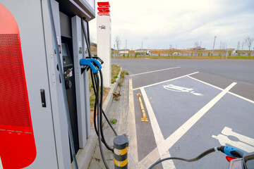 EV charging station with an electric vehicle. Zero emission car. Alternative energy. Electric...