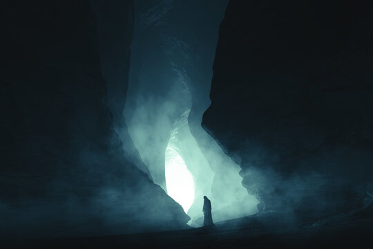 silhouette of a woman in cloak in dark cave