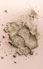 broken eye shadow scattered across the smooth pink surface. Texture background, advertising the structure of cosmetics. macro, copyspace