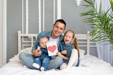 Fototapeta premium father's day concept, a girl daughter gives her beloved father a heart card for father's day or birthday