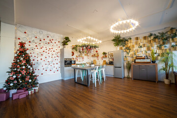 interior of a cozy modern spacious kitchen for a large family, decorated for the New Year celebration