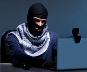 Hacker wearing balaclava mask hacking computer