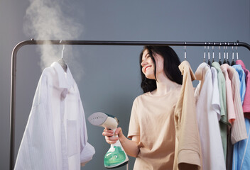 young brunette girl with steamer and clothes